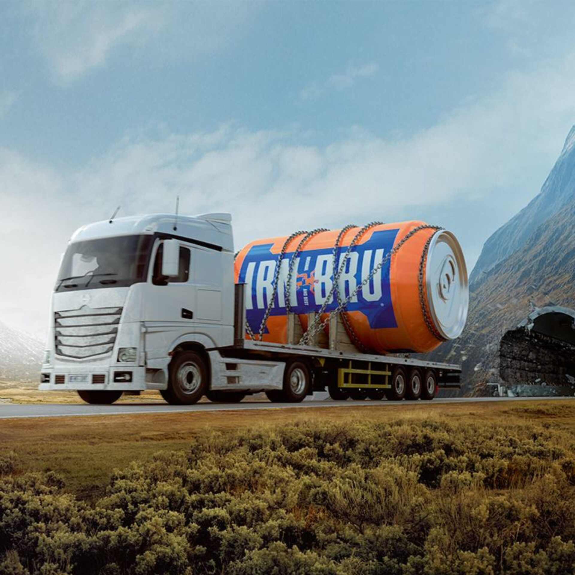 IRN-BRU branded truck carrying a giant orange can through a scenic Scottish-style landscape.